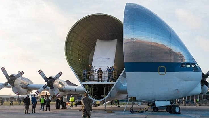 The nose of NASA’s Super Guppy aircraft opened to reveal the Orion spacecraft, wrapped in a protective transportation cover. The spacecraft was removed from the aircraft and loaded onto a large flatbed trailer to be transported to NASA’s Plum Brook Station for testing.