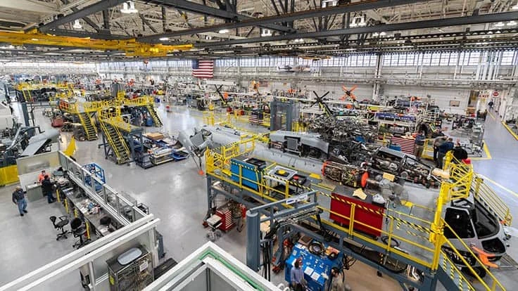 Sikorsky employees building CH-53K aircraft using 3-D work instructions, new titanium machining centers with multi-floor ergonomic platforms.