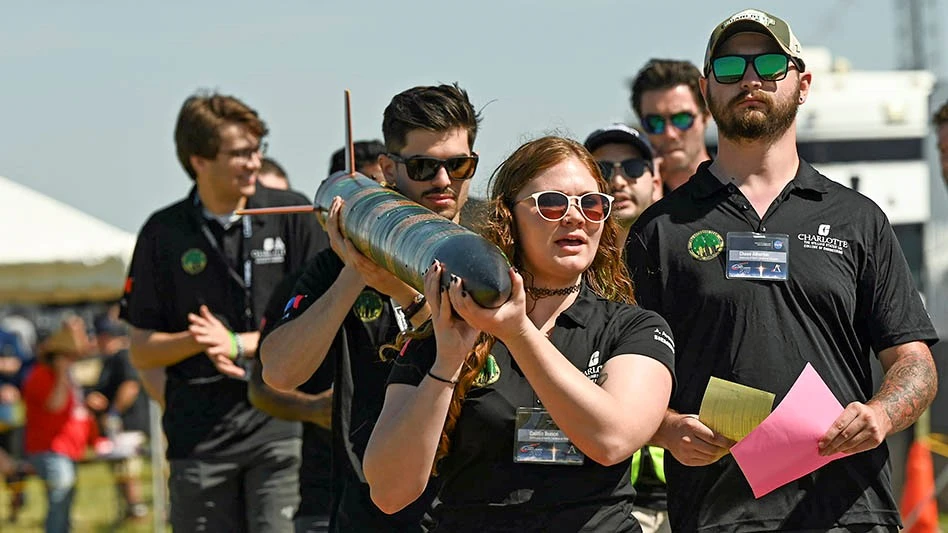 University of North Carolina at Charlotte team members carry their rocket to the launch area near NASA’s Marshall Space Flight Center in Huntsville, Alabama. The team won first place in the Launch Division.